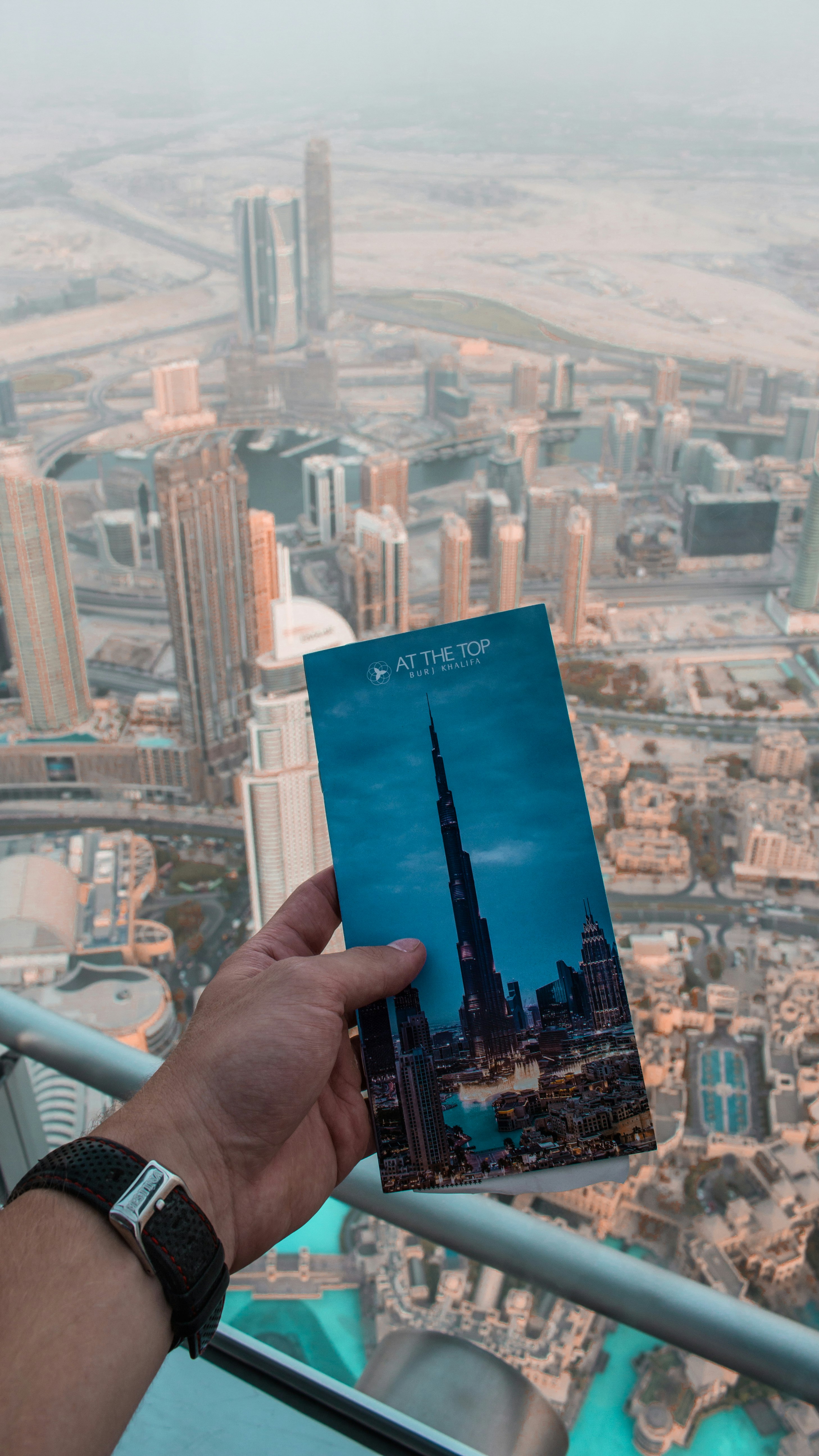 person holding blue and white book